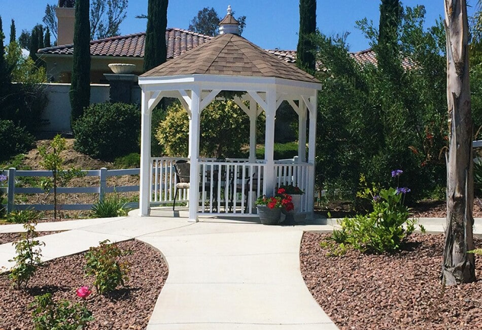 Gazebo-In-A-Box with chairs inside & flowers & trees