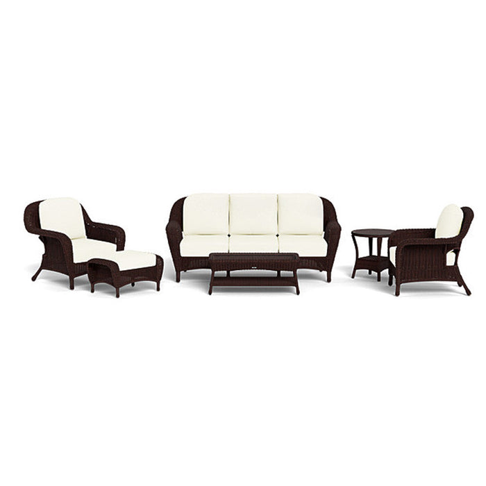 The Tortuga Outdoor Sea Pines 6-Piece Outdoor Wicker Sofa Set in Java includes a lounge chair with ottoman, three-seat sofa, loveseat, coffee table, and side table with white cushions—perfect for elevating your patio’s style and comfort.