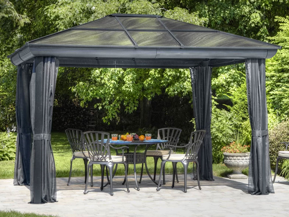 Full view of a venus gazebo 10x12 with privacy curtains partially drawn back on a garden setting
