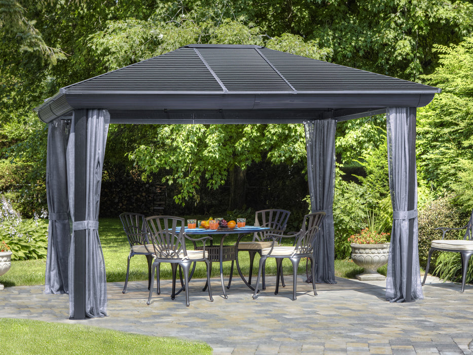 Full view of a metal roof gazebo with privacy curtains partially drawn back on a garden setting