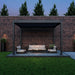 10x12 grand tuscan pergola over outdoor furniture set at night