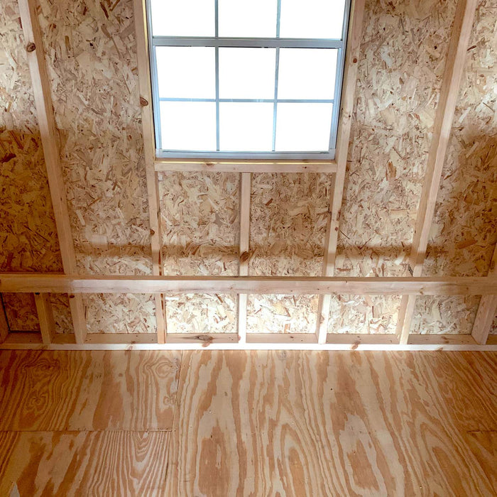 Interior view of the 10x16 Little Cottage Co. Round Roof Coop showcasing curved rafters, plywood floor, and natural wood framing.