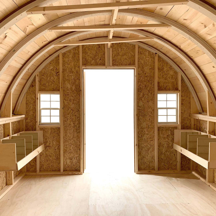 Inside view of the 10x16 Little Cottage Co. Round Roof Coop, featuring double nest boxes, arched rafters, and bright natural lighting.