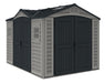 A Duramax Apex Pro 10.5 x 8 vinyl shed in beige and dark gray with a gable roof and skylight. It has two sets of wide double doors.