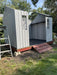 Lifetime 10x8 ft. storage shed during assembly, showing the open frame and roof structure before completion.