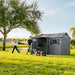 Man with a lawn mower and woman near the Lifetime 12.5x8 ft. storage shed with open door, lake in the background.