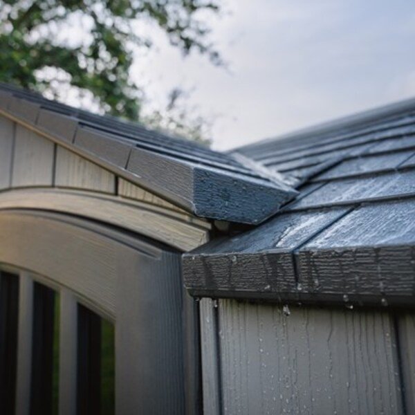 Close-up of the Lifetime storage shed's roof eave detail with water droplets.
