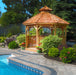 12' Bayside Panelized Octagon Gazebo in western red cedar beside a backyard pool, cedar shingle roof, cupola and arched entry railings