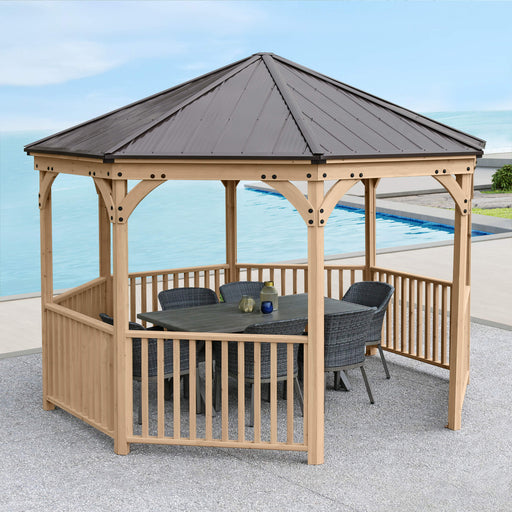 Yardistry  Octagon Gazebo placed beside a pool with chairs & a table.