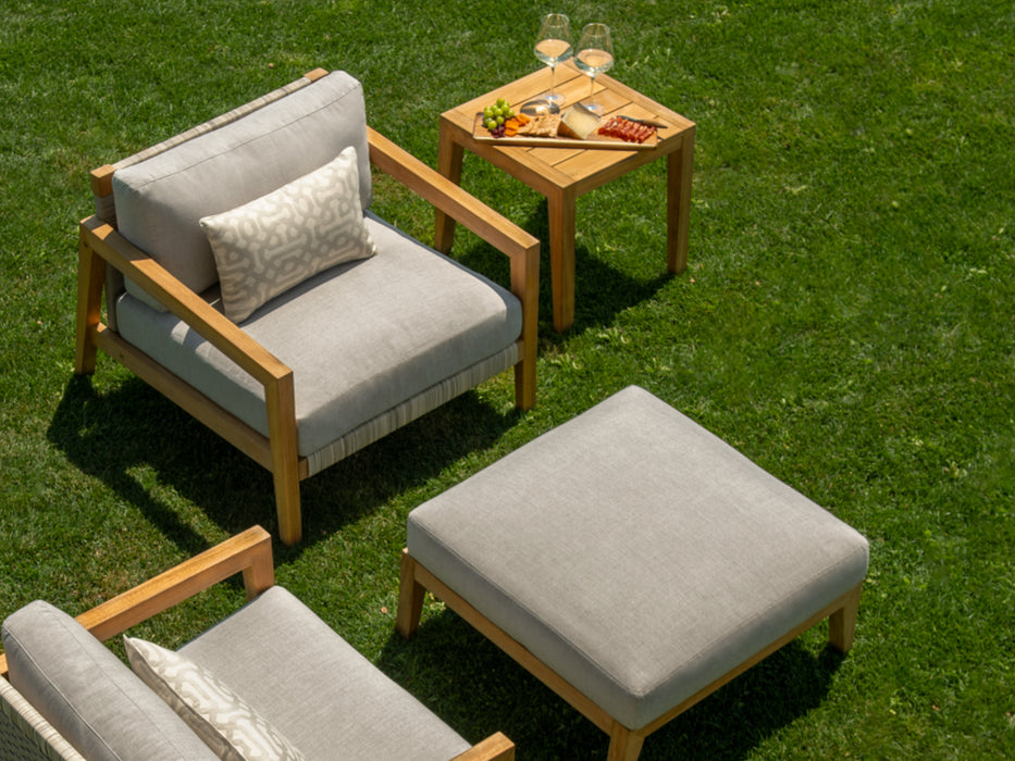 2 chat chairs ottoman and side table on the grass