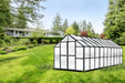 20 ft Growers Supply greenhouse with black aluminum frame and twin wall polycarbonate panels set on green backyard lawn