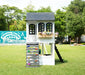 side angle of Reign Two Story Playhouse in a playground