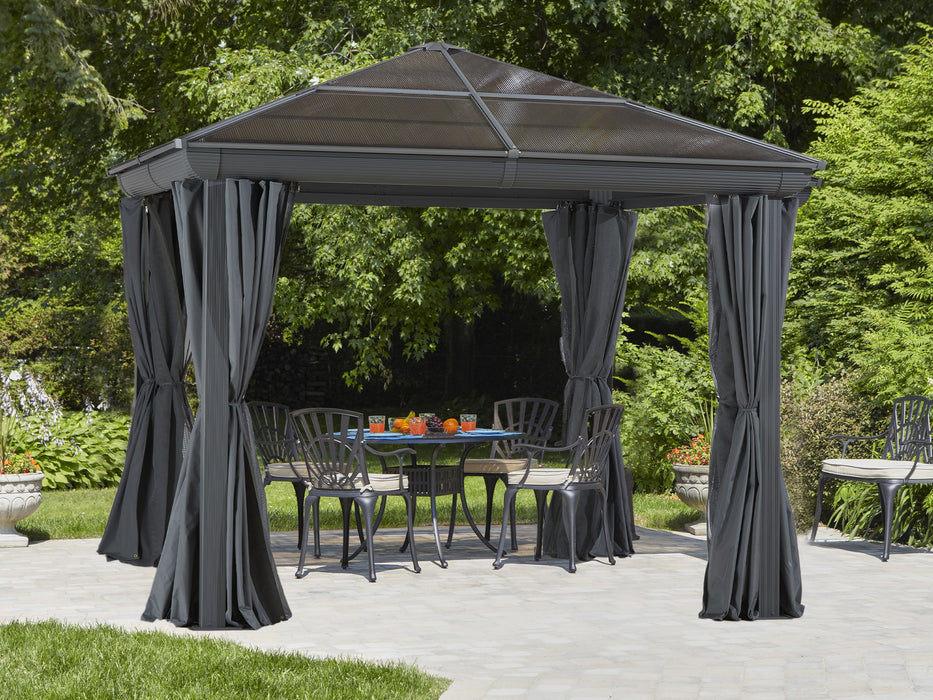 Full view of a 10x10 aluminum gazebo with privacy curtains partially drawn back on a garden setting