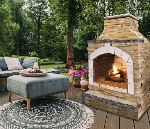 Cal Flame 48-Inch Outdoor Fireplace in the garden with sofa