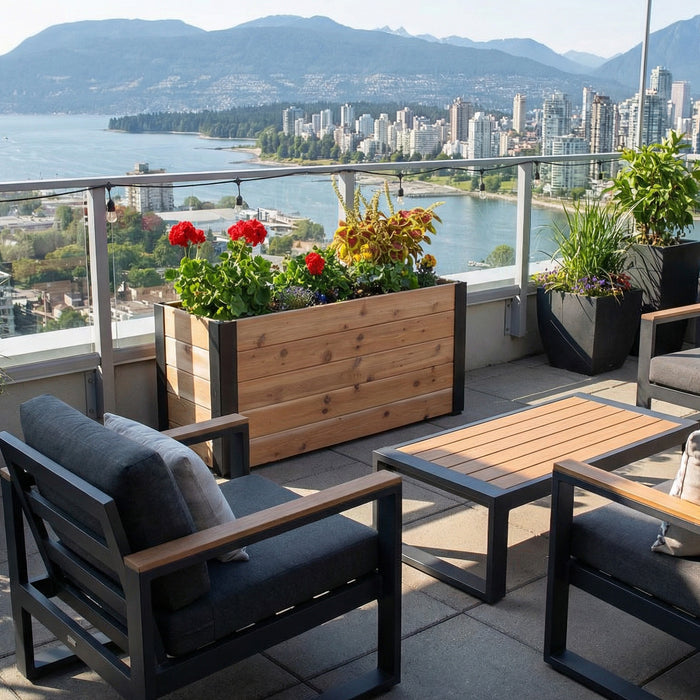 Cedar Urban Raised Garden Bed 4x1.5 on a rooftop terrace overlooking the city and water, planted with geraniums, coleus and trailing greens