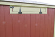 Close-up of a 5x8 portable chicken coop's ventilation system, showing the precision-cut vents and sturdy metal hardware.