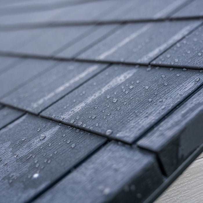 Close-up of gray roof shingles with water droplets on the Lifetime 8 Ft. x 15 Ft. Outdoor Storage Shed, emphasizing the texture.