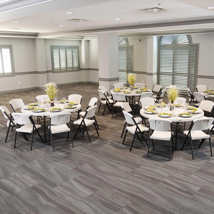 Event setup using Lifetime 4 Pack 60 Inch Round Nesting Table with white folding chairs arranged in banquet layout