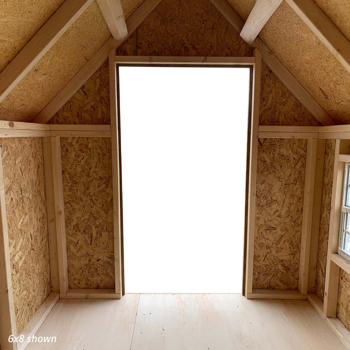 Inside view of the Little Cottage Co. Victorian Playhouse showing wood framing, open doorway, and side windows that bring in natural light.