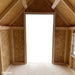 Inside view of the Little Cottage Co. Victorian Playhouse showing wood framing, open doorway, and side windows that bring in natural light.