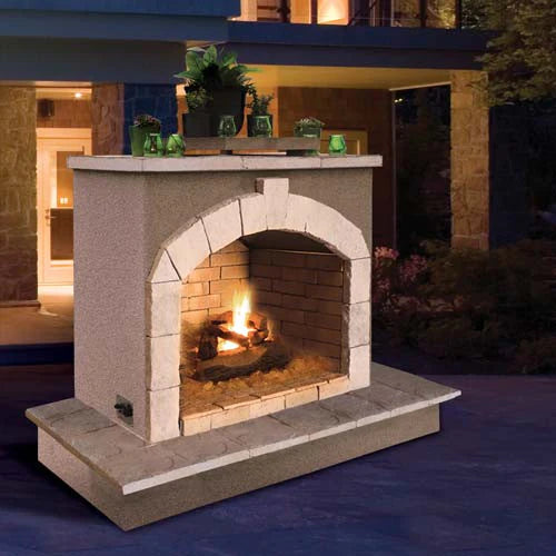 Cal Flame 72-Inch Outdoor fireplace placed outside the house at night