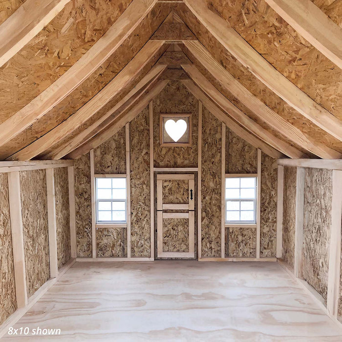 Little Cottage Co. 8x10 Gingerbread Cottage Playhouse interior view showing wooden framing, two square windows, and a signature heart-shaped gable window.