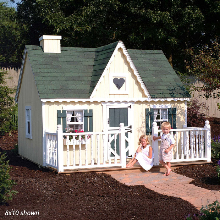 Little Cottage Co. 8x10 Victorian Playhouse with yellow siding and green trim, featuring two children sitting and playing on the white porch.