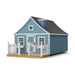 8x12 Gingerbread Cottage Playhouse by Little Cottage Co. in blue with white trim, deck and railing, heart window accent, and black shingle roof.