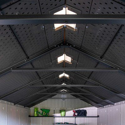 Interior view of the Lifetime 8x15 ft. storage shed looking up at the roof trusses and skylight panels.
