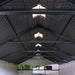 Interior view of the Lifetime 8x15 ft. storage shed looking up at the roof trusses and skylight panels.