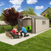 Man and daughter next to the Lifetime 8x20 ft. storage shed with open door, mower and kayak visible inside.