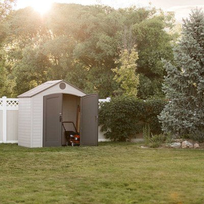 Lifetime 8x5 ft. storage shed in a backyard at golden hour, closed double doors.
