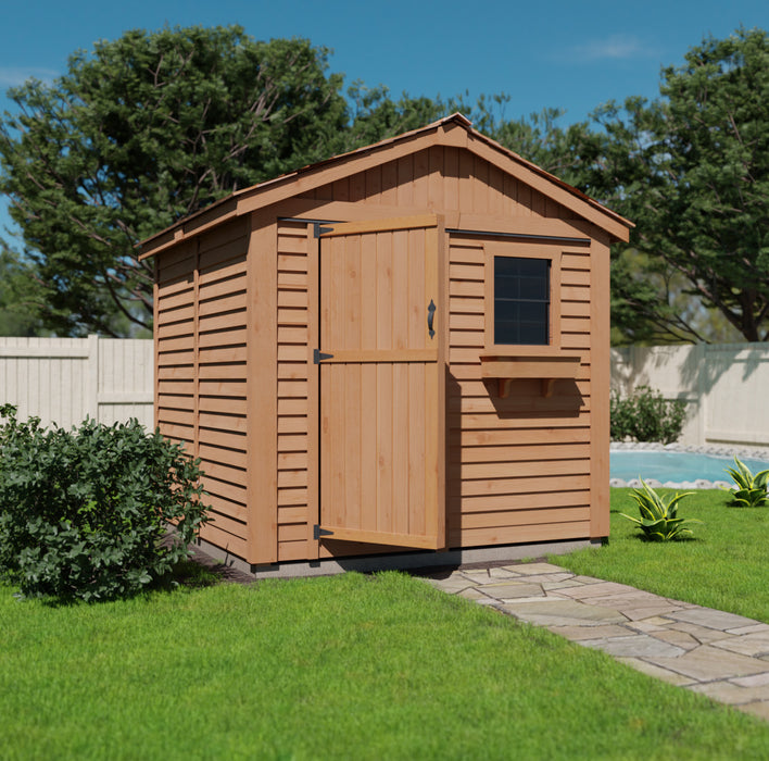 A wooden 8x8 Gardener Shed with a single door, positioned on a lush green lawn beside a stone pathway, surrounded by tall green trees under a clear sky.