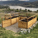 8x8 Garden in a Box in western red cedar on a gravel pad above a lake, U-shaped beds freshly filled with soil and young seedlings