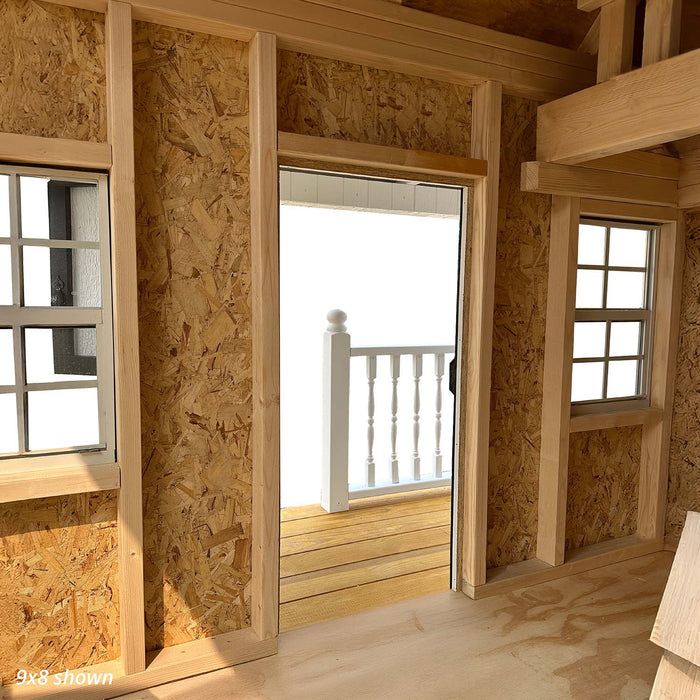 Interior view of the 9x8 Pennfield Cottage Playhouse showing wood framing, upper loft area, and detailed ceiling beams made of natural plywood.