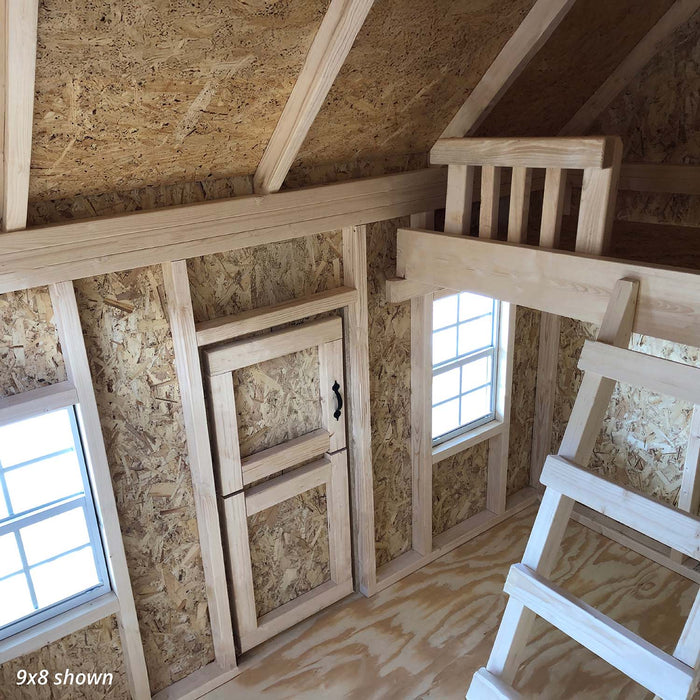 Interior of 9x8 Pennfield Cottage Playhouse highlighting loft area with wooden ladder, heart-shaped Dutch door, and natural OSB wall panels.