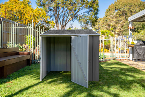 The 5x5ft Absco Multipurpose Metal Shed with opened side door placed in a backyard setting with pool in the background.