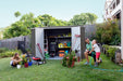 Father and children gathered around the opened Absco Premier 10' Metal Shed with tools inside, placed in a backyard.