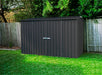 Absco 10 ft Outdoor Shed assembled and set against a wooden fence and grass in a backyard.