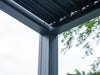 Close-up of the Stand Alone Pergola's corner showing the intersection of the horizontal and vertical beams. The connection points appear to be precisely engineered for stability and the structure is designed with a modern, squared profile.