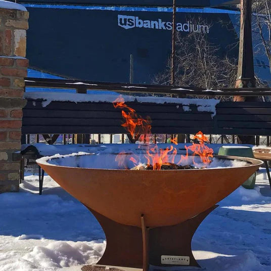 Durable Arteflame 40" Classic fire bowl in use during winter with snow around, showcasing versatility.