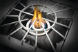The Napoleon Grills Burner in operation, with a cooking grate in place and a blue flame encircling the burner.