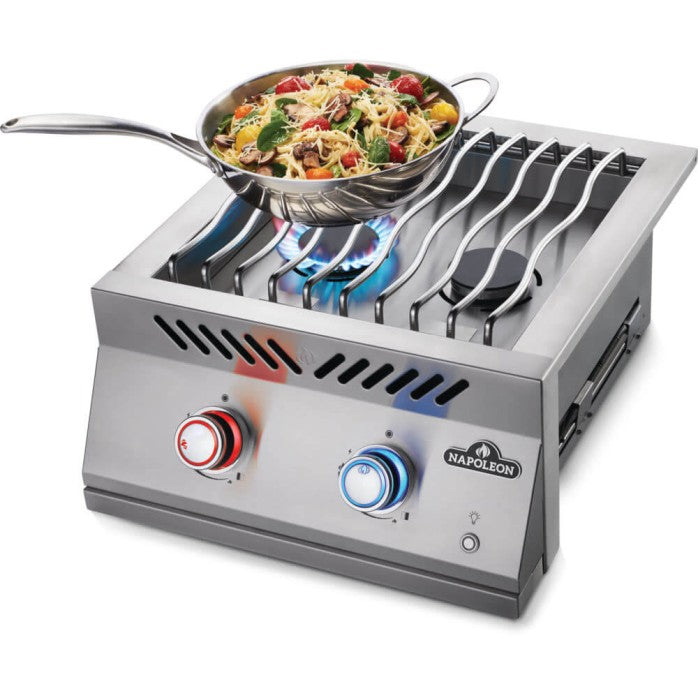Featuring a lit burner with blue flames under a silver pan, a red-accented control knob in the foreground