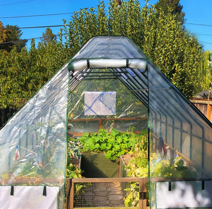 A Garden in a box 8 x 8 with Greenhouse with a lot of plants in it.