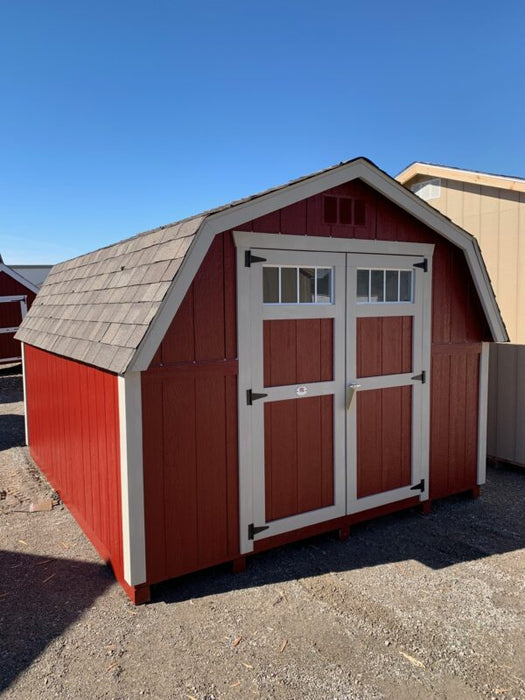 Rich red and white Colonial Greenfield Shed by Little Cottage Company with barn-style doors and trim.