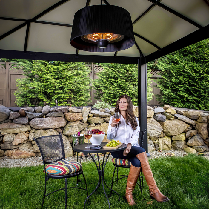 The Black Sol Pendant Electric Heater bathed in daylight, providing a comfortable and inviting outdoor environment for all-day enjoyment.