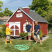 Three boys playing in the garden outside The Firehouse Playhouse by Little Cottage Company.