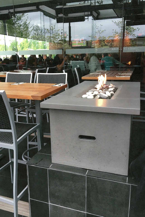 Cinder-colored Solus Firetable at Cactus Club, combining fine dining with contemporary outdoor warmth.