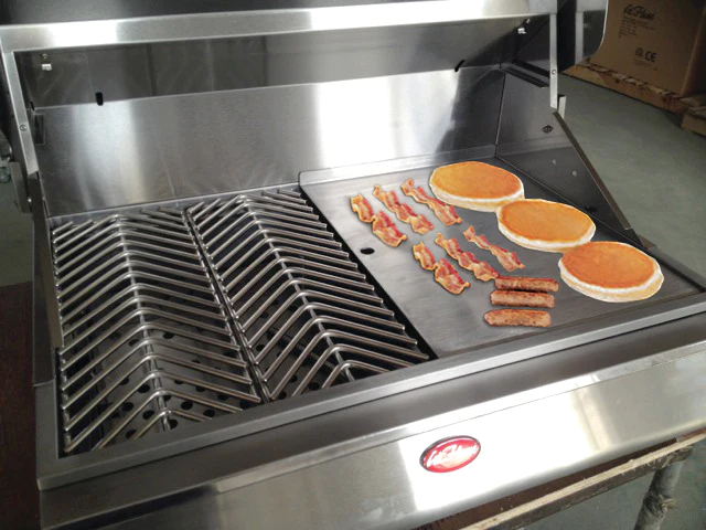 Pancakes and bacon sizzle on a stainless steel grill