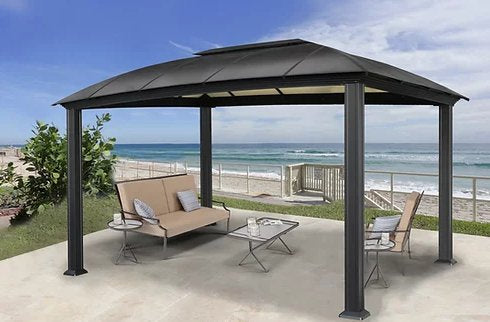 11x14 Cambridge Hard Top Gazebo On A beach front property with coastal furniture.